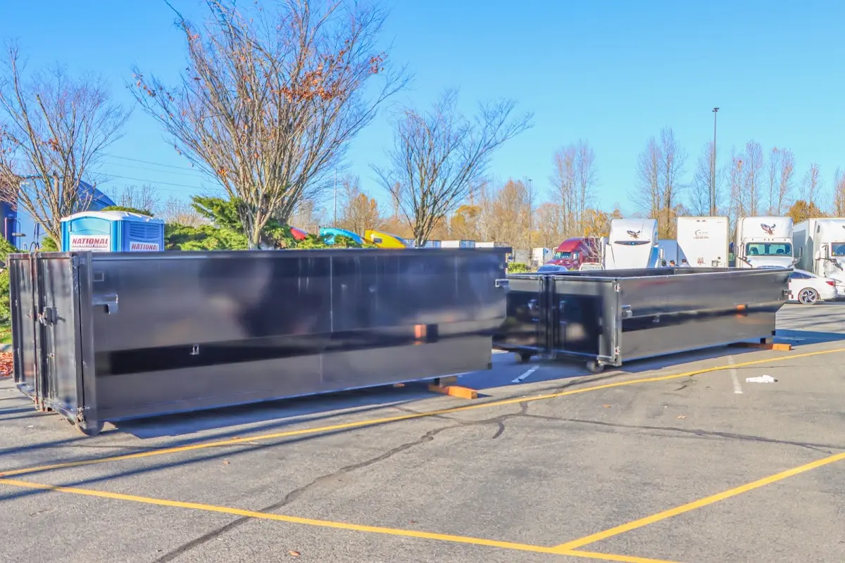 Professional dumpster rental service with roll-off container on residential driveway in Clarkstown